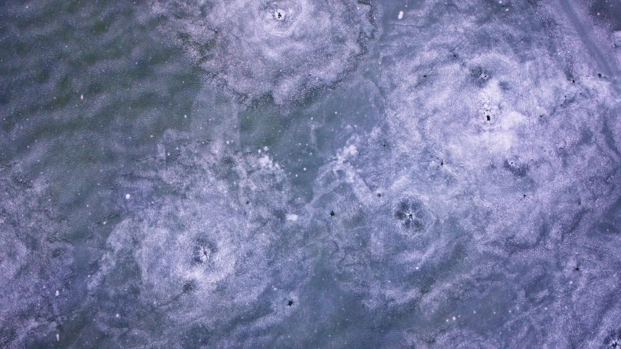 Overhead drone footage of frozen Great Lakes ice during cold winter conditions