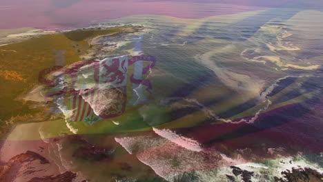 digital composition of waving spain flag against aerial view of sea waves