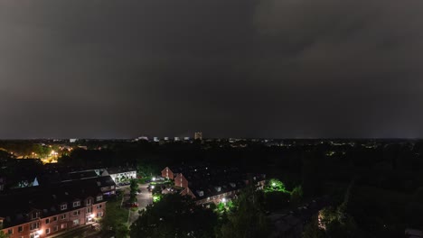 time lapse sequence of thunderstorm lightning at night over a village