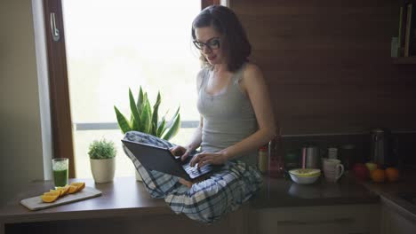 Atractiva-Mujer-Sentada-En-La-Mesa-Usando-Laptop