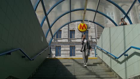 Woman Walking Upstairs in a Subway Station
