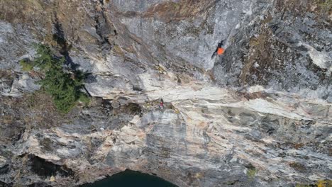 climber climbing rocky mountain 4k