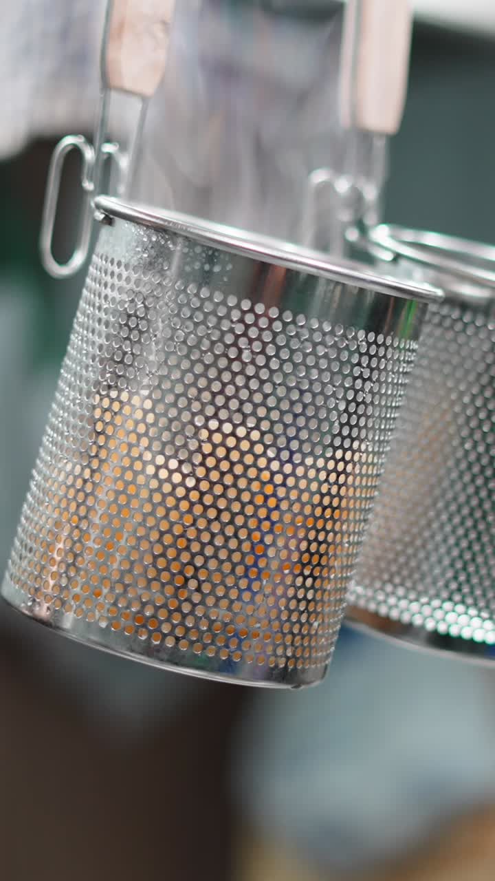 Steaming food in perforated metal baskets