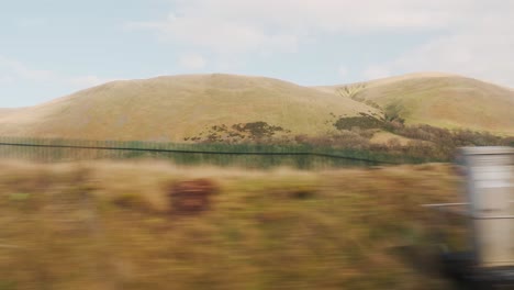 side pov driving past mountains and fields in bristol, england