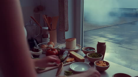 a person preparing food in a kitchen with various ingredients