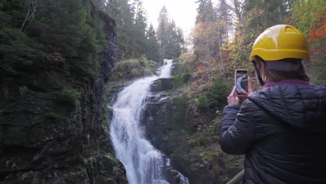 a woman traveler near a waterfall active recreation in a mountainous area a woman traveler near a waterfall active recreation in a mountainous area