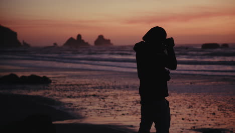silhouette of a photographer at sunset beach