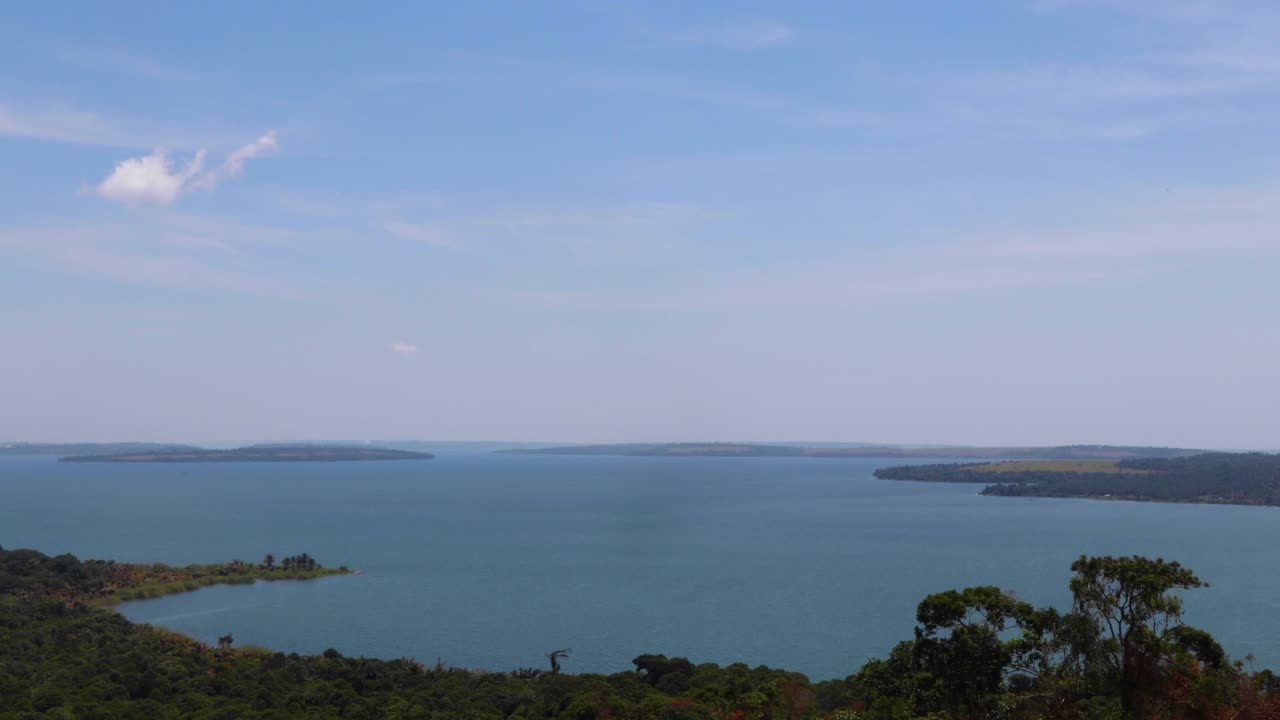 View from hill in Kalangala, Uganda. Time lapse of archipelago (Ssese Islands) in Lake Victoria. Small waves and scattered clouds in blue sky