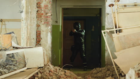 Person-holds-handgun-coming-into-premise-in-old-building