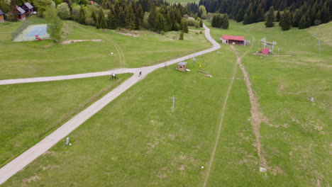 mountain bike rider cycling downhill through the beautiful rural countryside of liptov, slovakia