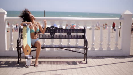 sexy young woman resting on her skateboard