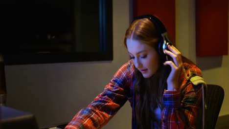 Female-audio-engineer-using-sound-mixer