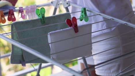 person hanging towels on a sunny day