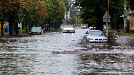 flooded streets with cars drawn by the water in european city