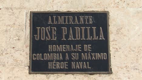 Commemorative plaque of the statue of Admiral Jose Padilla in front of the white colonial building in Cartagena, Colombia