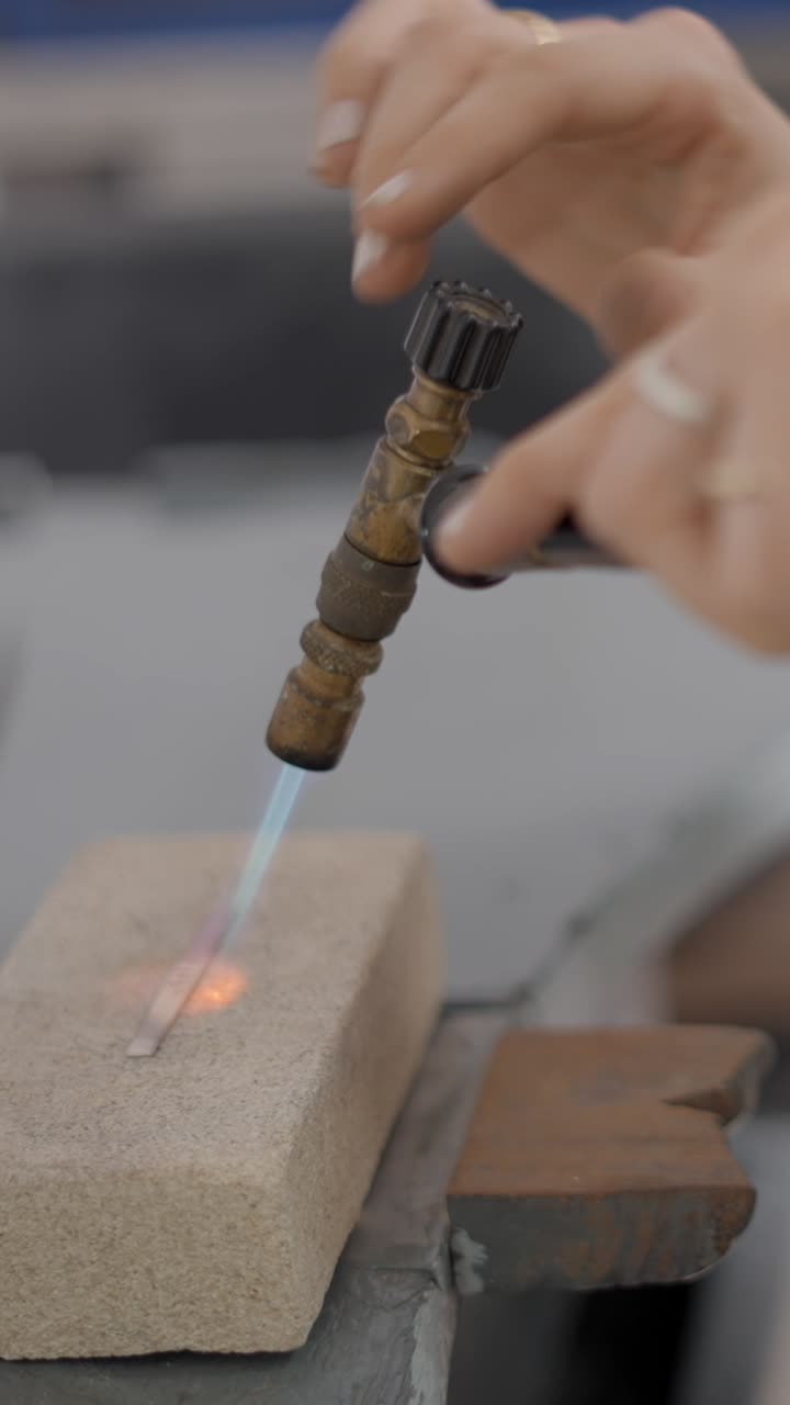 Artisan Soldering Metal with a Torch in a Workshop