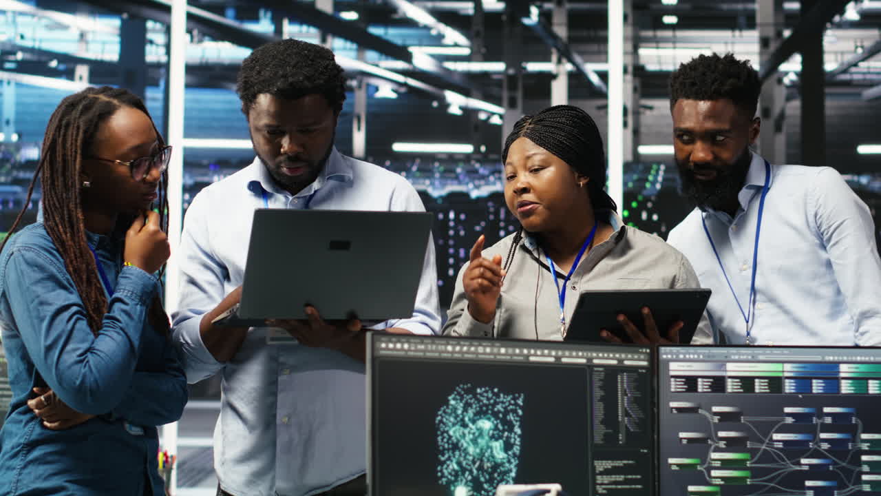 Portrait of smiling data center specialists collaborating in server facility