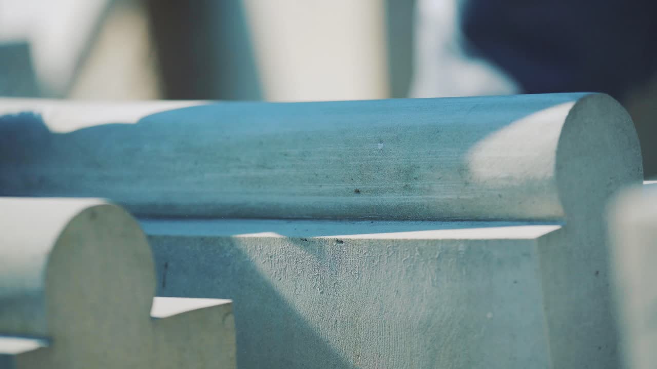 A man polishes sandstone with sandpaper. Production of decorative products and sculptures made of stone. Close-up