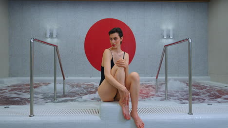 woman relaxing in modern spa hot tub