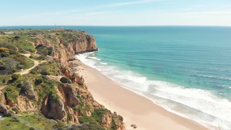 Canavial-Beach-seafront-on-the-Algarve-Golden-Coast-idyllic-Landscape,-Portugal---Aerial-Panoramic-Orbit-shot