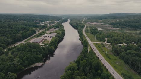 flying over magog river in suburban area of sherbrooke, canada - drone shot