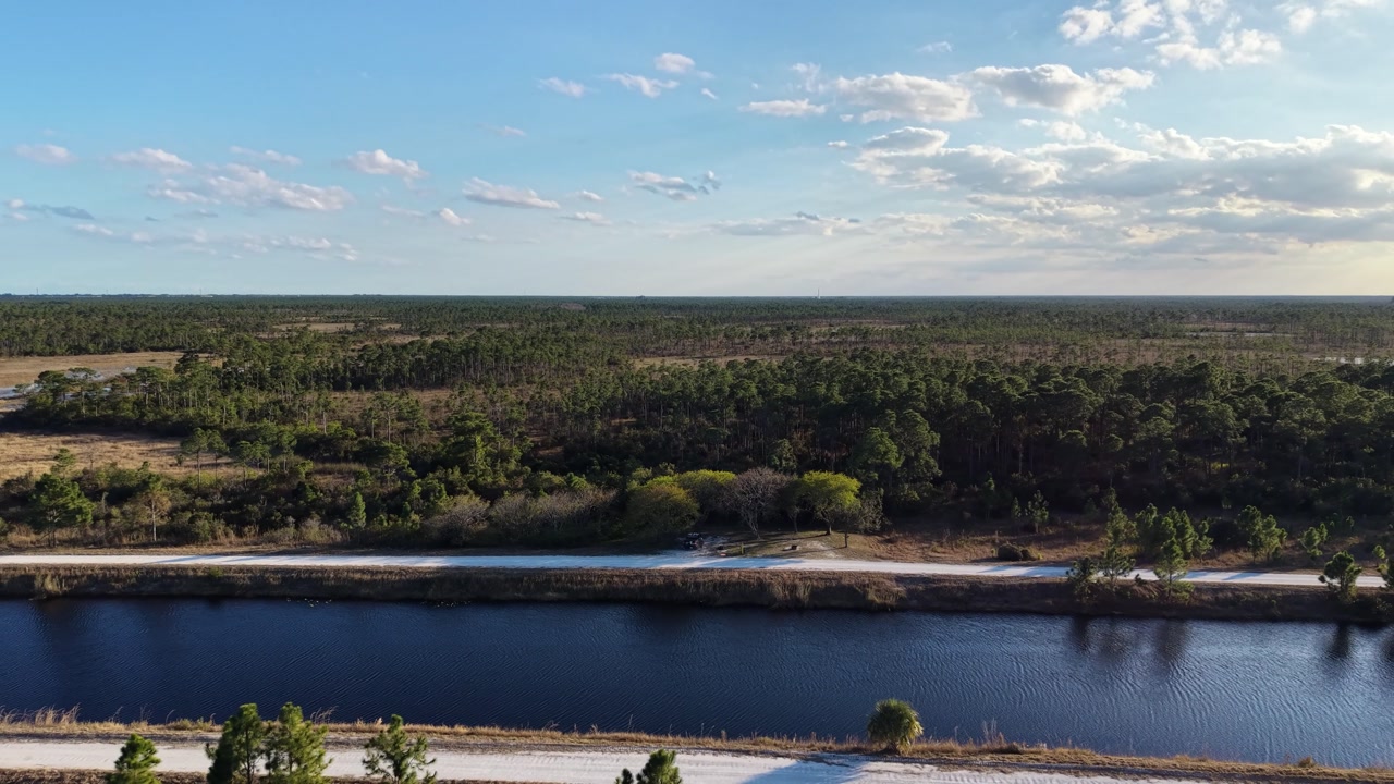 drone reveal shot at the John C. and Mariana Jones Hungryland Wildlife Environmental Area showing the vast expanse and diversity of the land including ponds, canals, lakes and prairies.