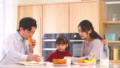 young happy family having healthy breakfast together in the morning in the kitchen at home