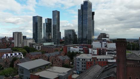 aerial drone flight over the rooftops of castlefield quays showing a view of the skyscrapers in manchester city centre