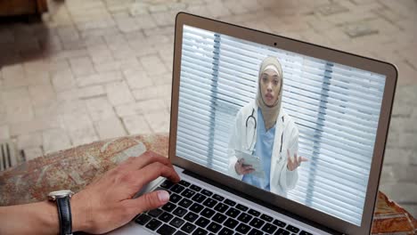 Man-having-a-video-conference-with-a-doctor