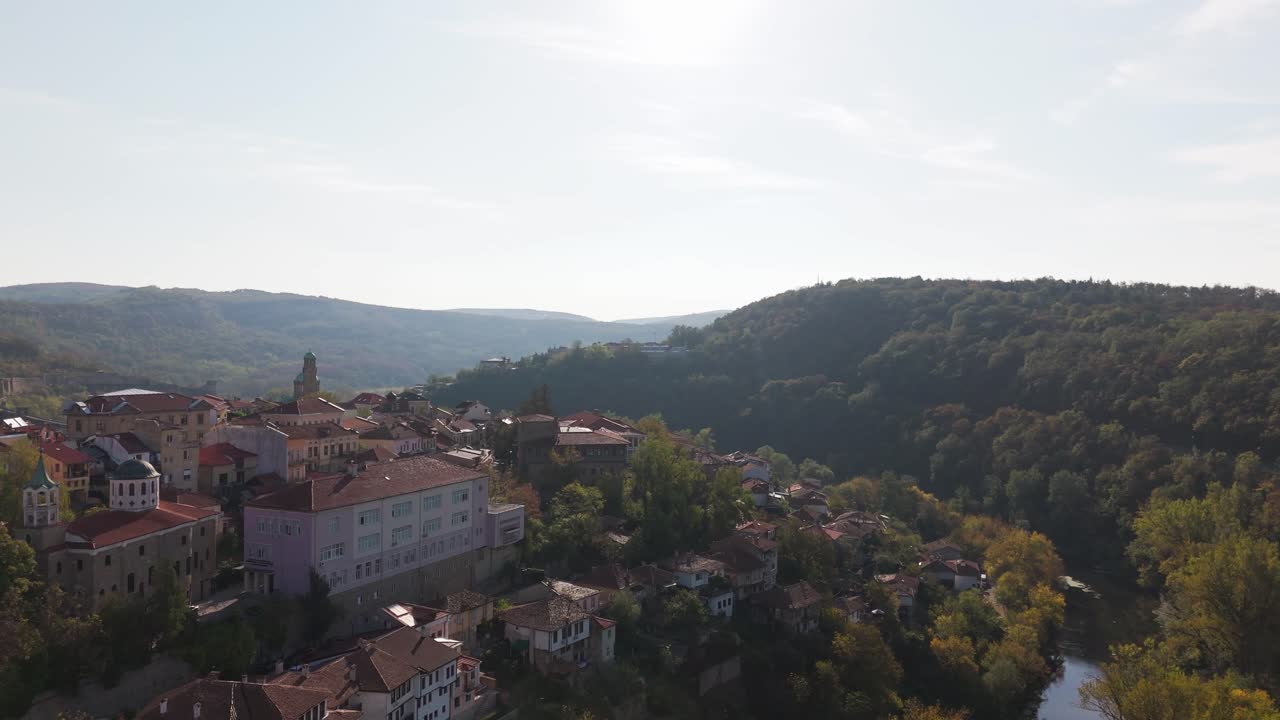 Smooth push-in shot over Veliko Turnovo, highlighting the rolling hills and charming townscape beneath clear skies.