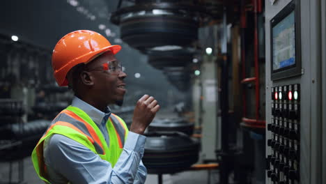 Closeup-engineer-looking-electronic-table-at-industrial-tyre-production-factory.