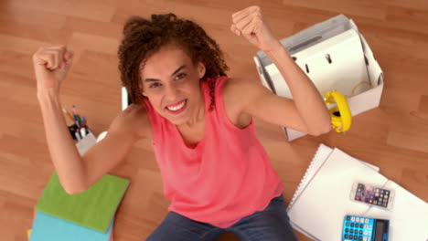 una mujer de negocios emocionada haciendo gestos de éxito.