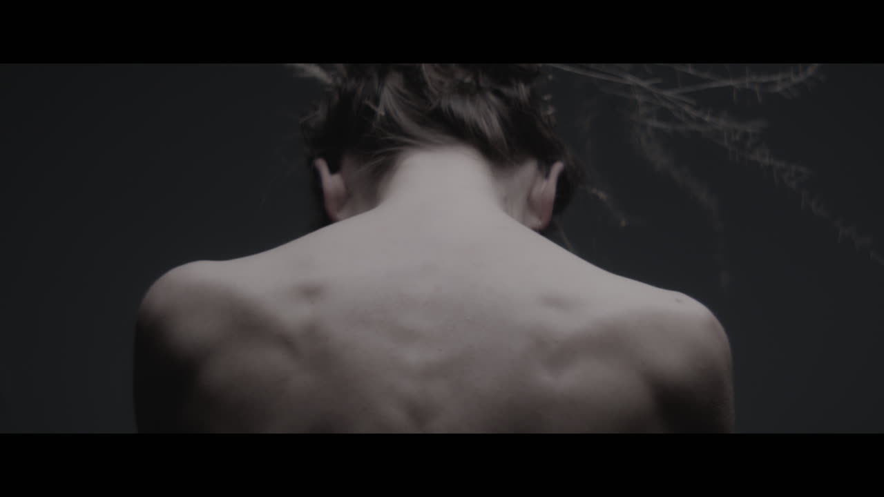 A woman dressed as mother nature shows her back