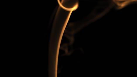 abstract shapes of orange smoke on black background.