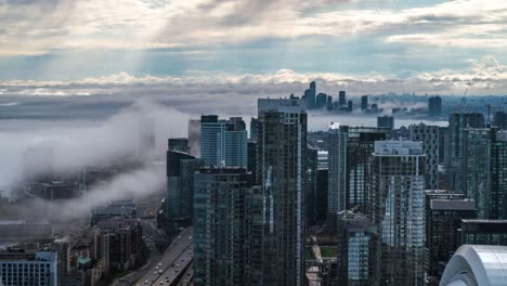 toronto, ontario, canada, timelapse view of toronto cityscape showing modern buildings in the financial district on a foggy day