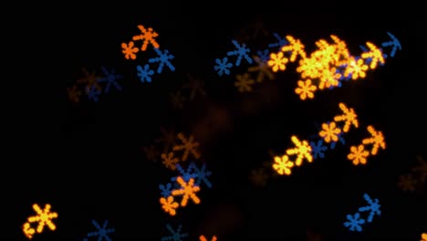 Beautiful-snowflake-shape-bokeh-from-flashing-LED-lights,-Christmas,-winter,-holiday-or-glamour-party-background-concept,-copyspace