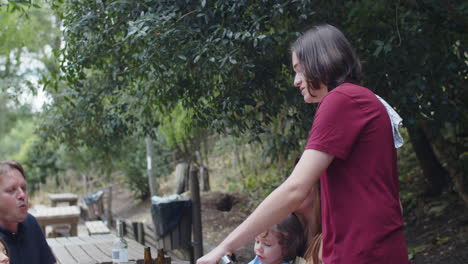 happy caucasian family spending time together, grilling meat and vegetables, talking and laughing