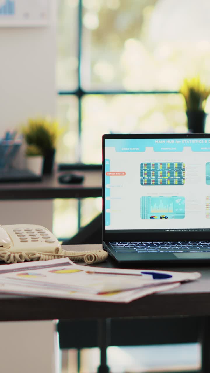 Vertical video Stock market diagrams with charts and stock figures on laptop sitting on desk