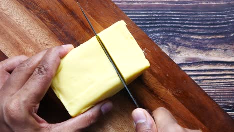 cutting butter on a wooden cutting board