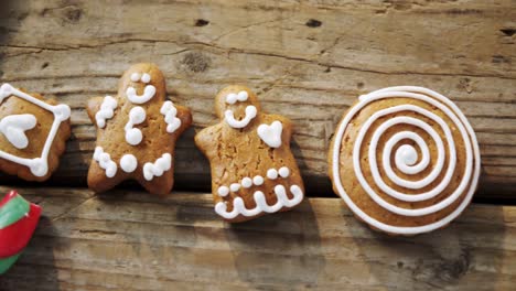 various cookies and candy cane arranged on wooden table 4k