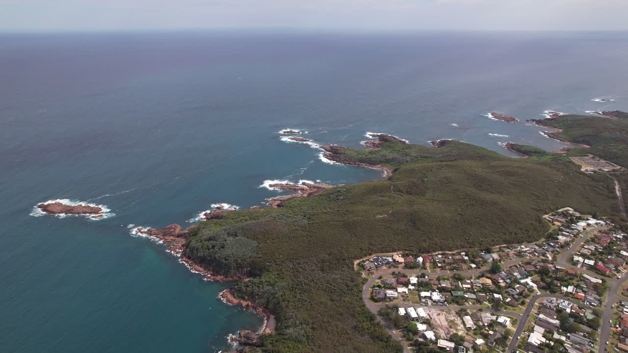Forested Headland Of Fingal Bay And Suburb In Port Stephens, NSW, Australia. aerial pullback shot