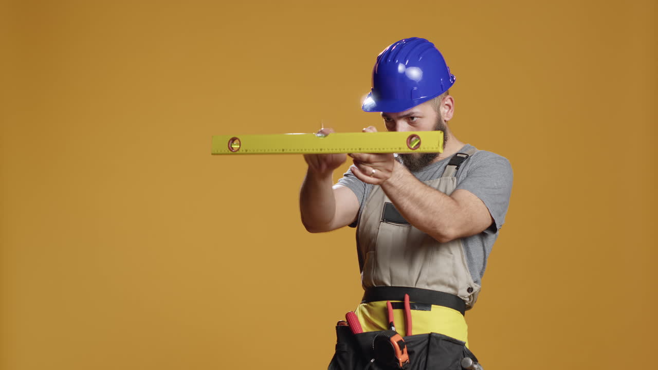 Construction builder working with water level tool to do measurement