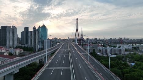 drone aerial view of traffic and highway in the city during sunset