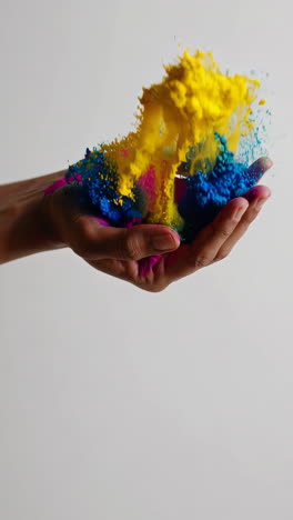 colorful powder exploding from a hand