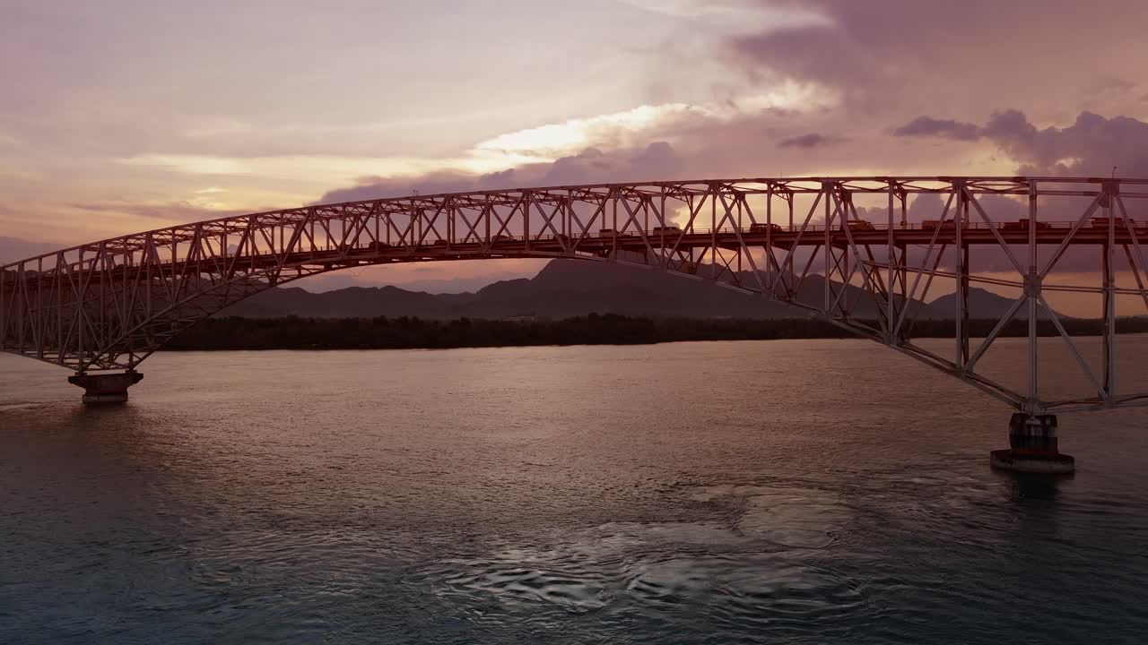 Slow moving traffic crossing the San Juanico Bridge at sunset from Samar to Leyte in the Philippines