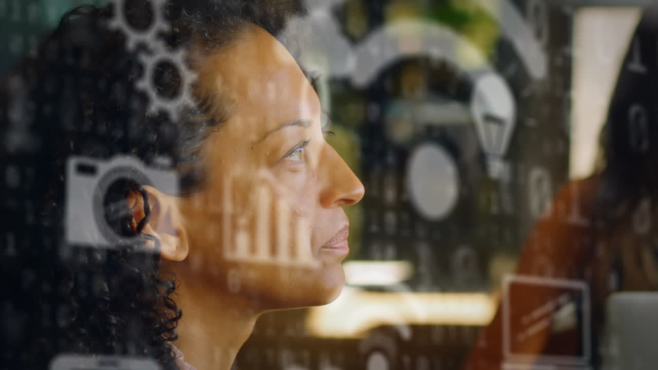 Animation of multiple icons over binary codes against thoughtful biracial woman at office