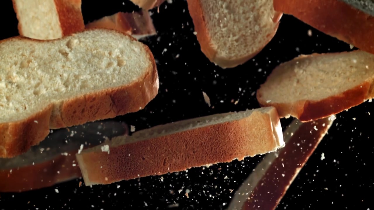 Slices of Fresh Bread Falling in Slow Motion with Crumbs
