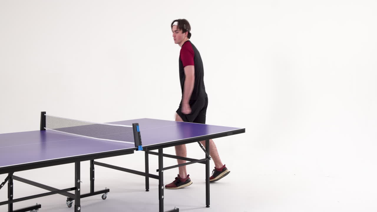 Playing table tennis, man in sportswear preparing for next serve