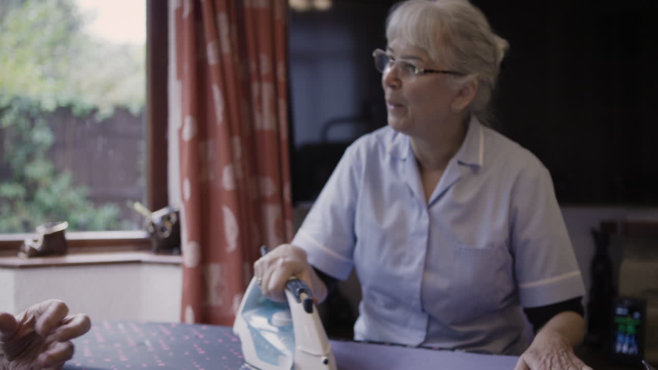 Woman ironing clothes indoors