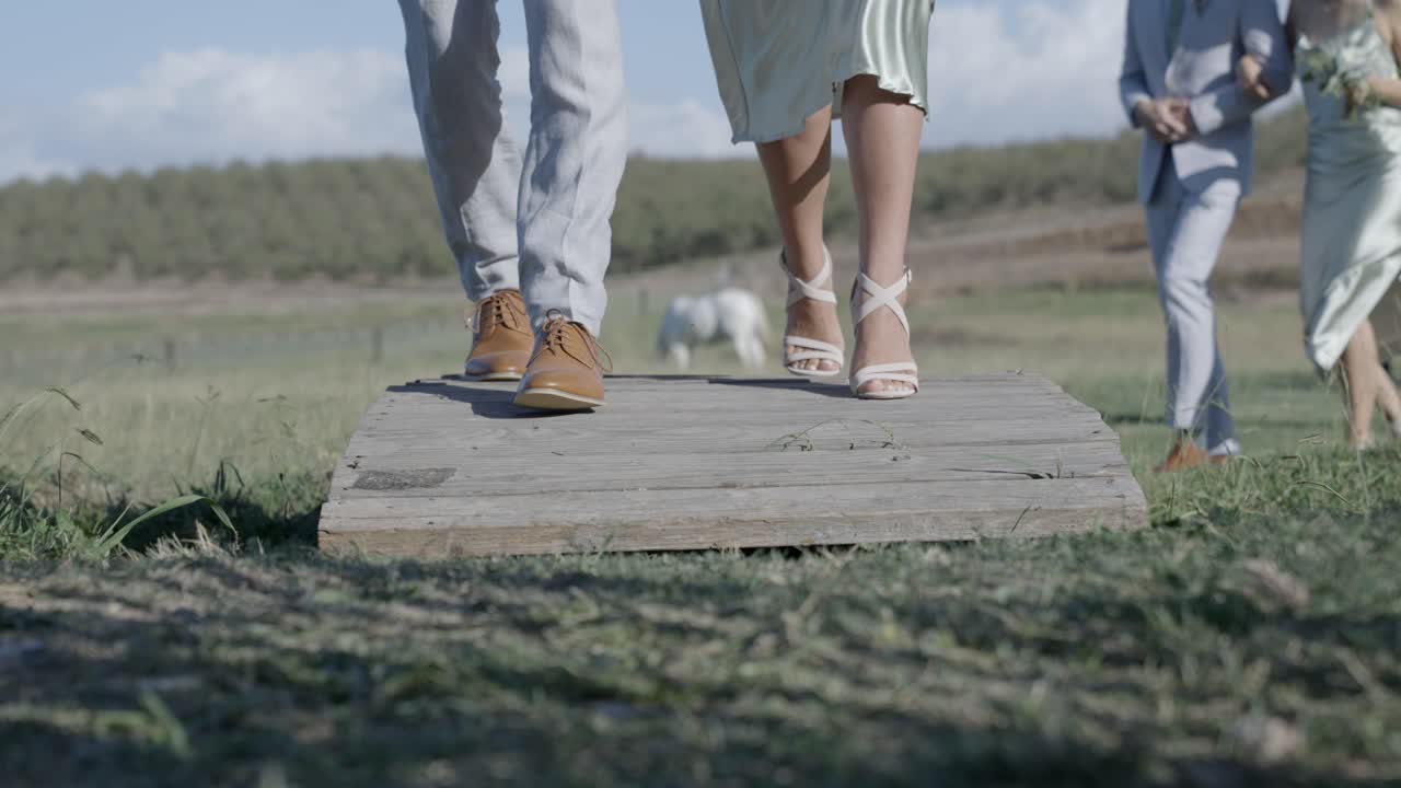A couple from a bridal party cross over small bridge after wedding ceremony.  Email willneathery yahoo.com to purchase the entire wedding event,both raw and edited, at cheap wholesale pricing.